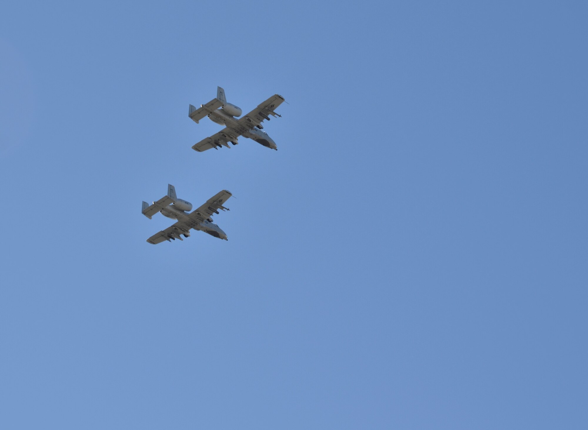 Two A-10 Thunderbolt IIs from the 442d Fighter Wing, Whiteman Air Force Base, Mo., fly over Paige Field at the Sprint Campus in Overland Park, Kan., Nov. 10, 2016. Community members gathered at Paige Field for the 9th annual Veterans Day Celebration to thank service members and veterans while learning more about military history, equipment and missions. (U.S. Air Force photo/Senior Airman Missy Sterling)