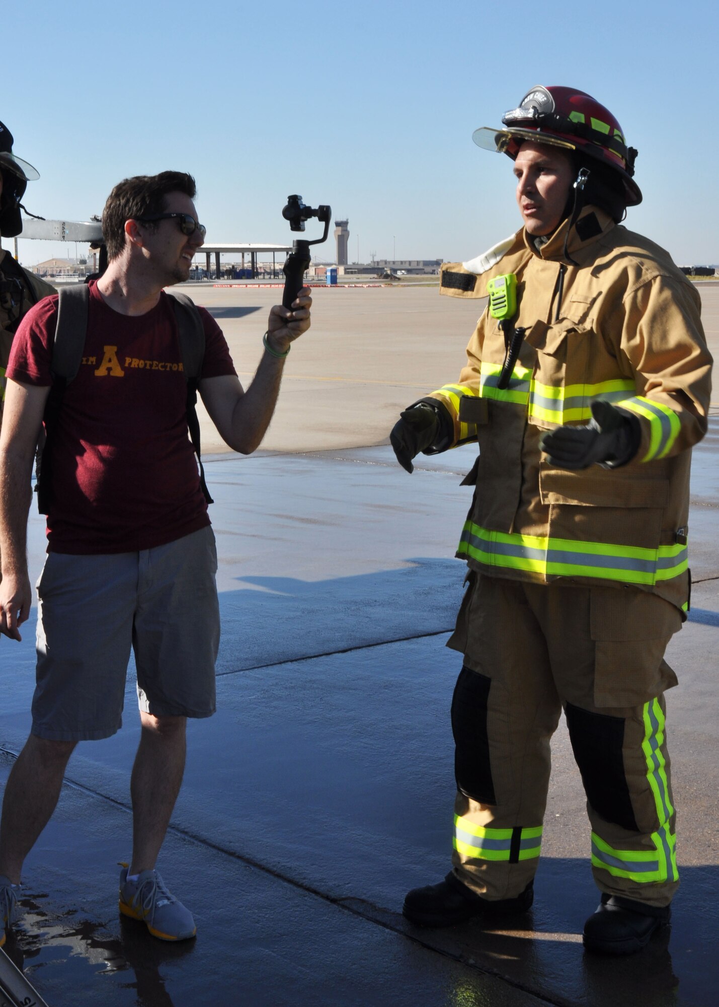 Josh Kelman, an Arizona State University representative, interviews Tech. Sgt. Gabe Ulibarri, 944th Civil Engineer Squadron firefighter, Nov. 6 during an annual egress
training exercise. (U.S. Air Force photo by Tech. Sgt. Barbara Plante)
