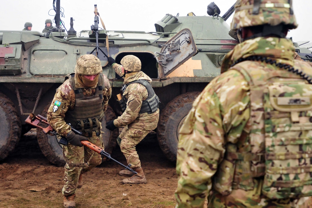 Army 1st Sgt. Jovanny Jones, right, observes Ukrainian soldiers assigned to 1st Battalion, 80th Airmobile Brigade dismounting a BTR armored personnel transport during a live-fire training exercise at the International Peacekeeping and Security Center in Yavoriv, Ukraine, Nov. 12, 2016. The U.S. soldiers are assigned to 6th Squadron, 8th Cavalry Regiment, and are deployed in support of Joint Multinational Training Group Ukraine. The unit directs training of Ukrainian ground forces and helps to build an enduring and sustainable training capacity for the future. Army photo by Sgt. Jacob Holmes
