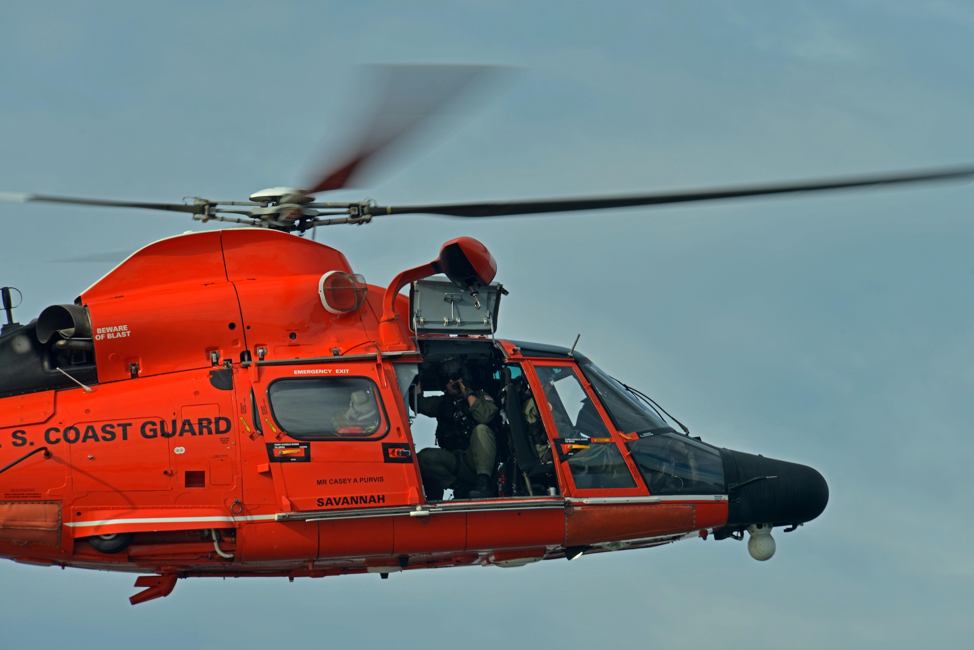 A U.S. Coast Guardsman looks out of an MH-65 Dolphin at Coast Guard Station Tybee, Ga., Nov. 8, 2016. The Dolphin is a short-range recovery helicopter capable of all-weather and night-time operations, with the exception of icing conditions. (U.S. Air Force photo by Airman 1st Class Destinee Sweeney)