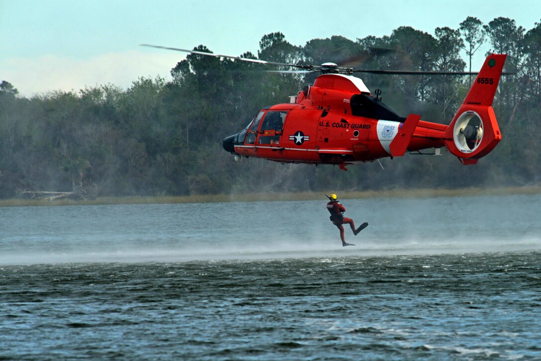A U.S. Coast Guardsman jumps out of an MH-65 Dolphin at Coast Guard Station Tybee, Ga., Nov. 8, 2016. The helicopter crew and the swimmer played a part in water survival training for 20th Fighter Wing pilots assigned to Shaw Air Force Base, S.C. (U.S. Air Force photo by Airman 1st Class Destinee Sweeney) 