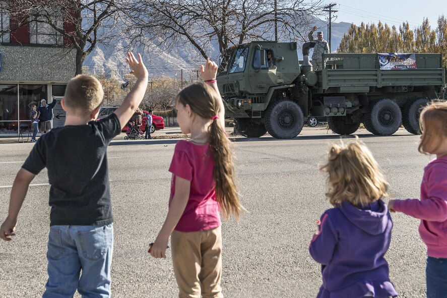 Col. David Dunklee, 75th Air Base Wing vice commander, waives to families lining the streets during the Ogden Veterans Day Parade Nov. 12 in downtown Ogden. (U.S. Air Force photo by Paul Holcomb)