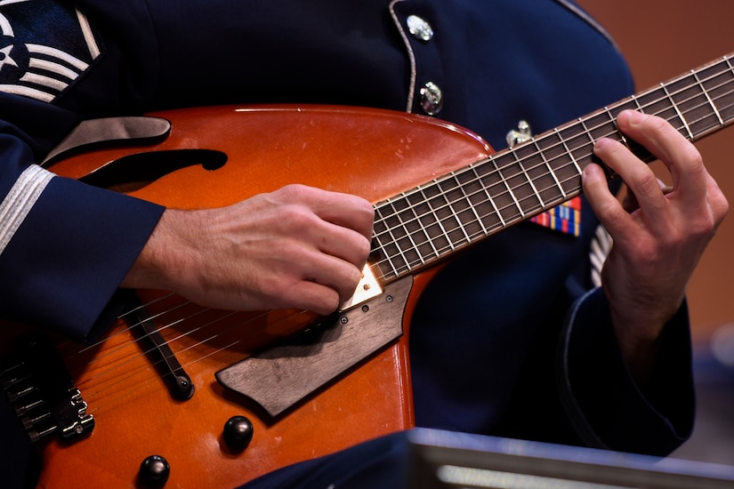 An Airmen of Note member strums the guitar at the Jazz Heritage Series at the Rachel M. Schlesinger Concert Hall in Alexandria, Va., Nov. 11, 2016. The Airmen of Note played alongside a legendary jazz artist. Each year the series is broadcasted to millions over National Public Radio, independent jazz radio stations, satellite radio services and the Internet. (U.S. Air Force photo by Airman 1st Class Valentina Lopez)