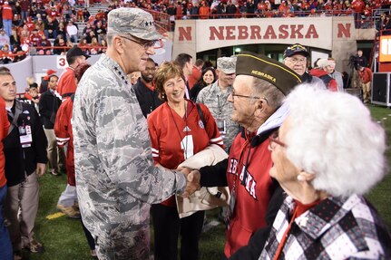 Gen. John E. Hyten, commander of U.S. Strategic Command (USSTRATCOM), greets a veteran prior to the Nebraska Cornhuskers – Minnesota Golden Gophers college football game Nov. 12, 2016, where he was the guest of university president Hank Bounds. The university also provided game tickets to veterans and active duty personnel assigned to USSTRATCOM and area commands as part of the Veterans Day weekend. One of nine DoD unified combatant commands, USSTRATCOM has global strategic missions assigned through the Unified Command Plan that include strategic deterrence; space operations; cyberspace operations; joint electronic warfare; global strike; missile defense; intelligence, surveillance and reconnaissance; combating weapons of mass destruction; and analysis and targeting. (U.S. Navy photo by Petty Officer 1st Class Byron C. Linder)