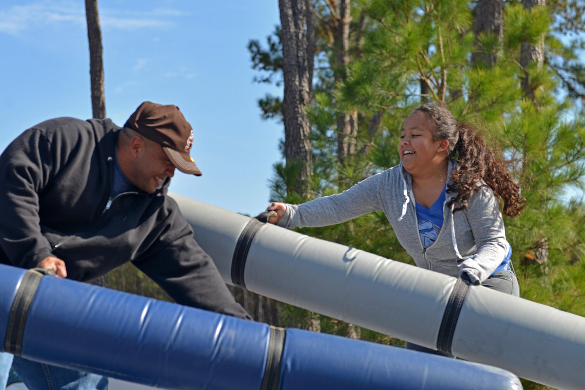 U.S. Army Sgt. 1st Class Chris Walters, U.S. Army Central corrections and detention NCO in charge, and Crislyn Walters, his daughter, play with pugil sticks during a Team Shaw Fall Family Picnic at Shaw Air Force Base, S.C., Nov. 12, 2016. The Team Shaw Rising Four hosted the Team Shaw Fall Family Picnic to bring together Team Shaw families and boost the morale of individuals unable to go home during the holiday season. (U.S. Air Force photo by Airman 1st Class Destinee Sweeney)