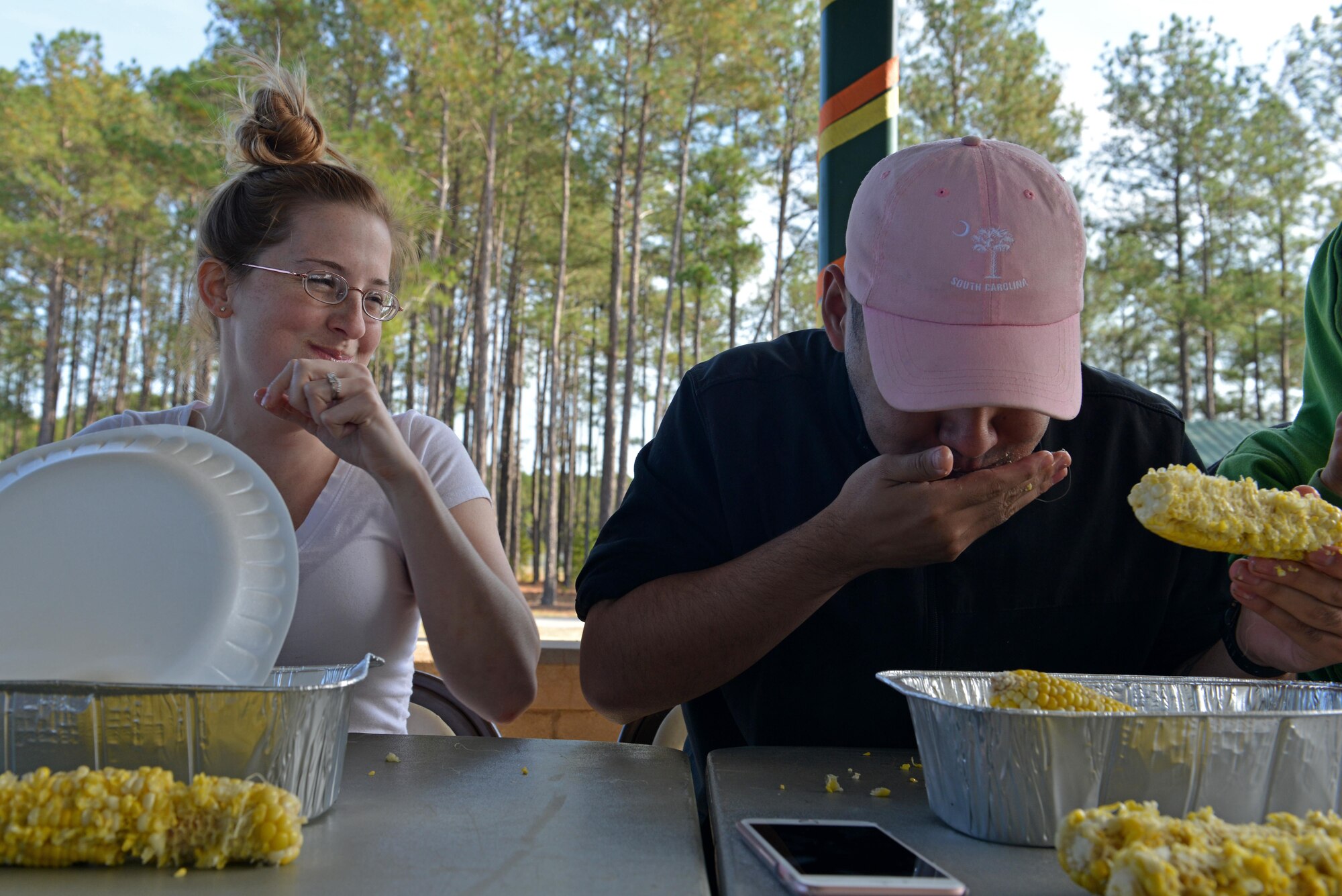 Jessica Venegas, Team Shaw spouse, and U.S. Air Force Airman Justin Foose, 20th Aerospace Medicine Squadron public health medical technician, compete during a corn-eating contest at Shaw Air Force Base, S.C., Nov. 12, 2016. The corn-eating contest was one of the many activities hosted at the second-annual Team Shaw Fall Family Picnic. (U.S. Air Force photo by Airman 1st Class Destinee Sweeney)