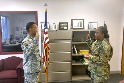 Sgt. Roje Rogers, left, Supply Sergeant, 85th Support Command, recites the oath of enlistment during a reenlistment ceremony at the command headquarters, Nov. 8, 2016.
(Courtesy photo)