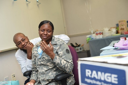 Army Reserve Chief Warrant Officer 3 Monique Perkins, Human Resources Technician, 85th Support Command, reacts to a gift for her baby during a surprise baby shower luncheon, Nov. 9, 2016. Perkins is due next month.
(Photo by Anthony L Taylor)