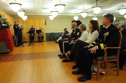 (Right to left) Deputy Commander of U.S. Strategic Command’s (USSTRATCOM) Joint Functional Component Command for Global Strike (JFCC-GS) Rear Adm. Thomas E. Ishee; his wife Jerrilyn Ishee; Kathy McCoy, wife of 6th Chief Master Sgt. of the Air Force Jim McCoy; and Command Sgt. Maj. Nathaniel Jett, JFCC-GS command sergeant major, listen to the U.S. Air Force Heartland of America Band brass ensemble during the Eastern Nebraska Veterans’ Home annual Veterans Day program in Bellevue, Neb., Nov. 11, 2016.  The program celebrated the residents who live there along with veterans worldwide. Veterans Day was originally referred to as “Armistice Day” because it was celebrated on the same date that World War I hostilities ended on the 11th hour of the 11th day of the 11th month in 1918. On June 1, 1954, President Dwight D. Eisenhower officially changed the name to Veterans Day, celebrated on Nov. 11 each year, a day to honor American veterans of all wars. (USSTRATCOM photo by Steve Cunningham) 