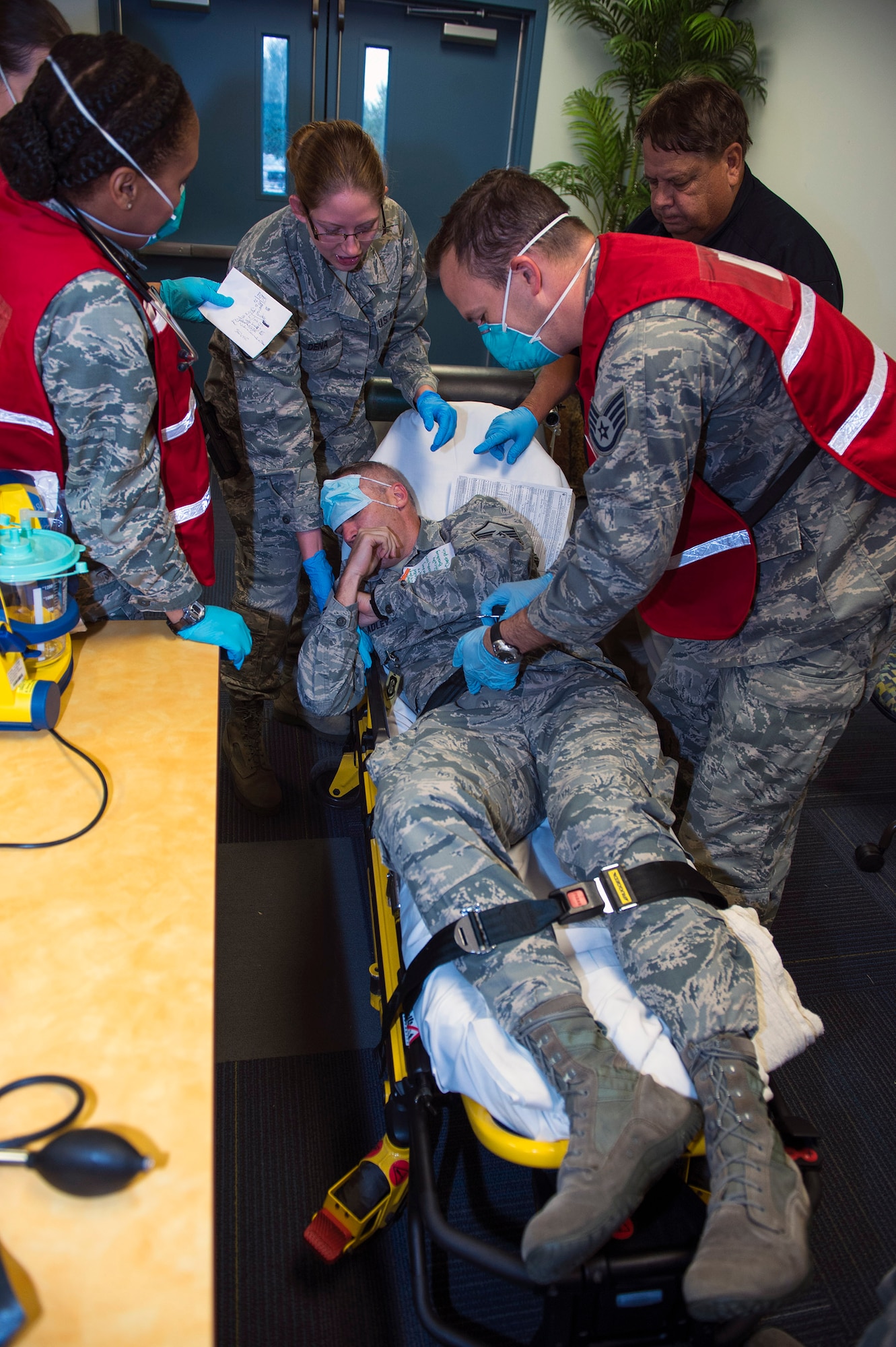 Members of the 23d Medical Group assess Master Sgt. Jason Bradley, 23d Medical Operations Squadron family health flight chief, for simulated flu-like symptoms during a surge exercise, Nov. 9, 2016, at Moody Air Force Base, Ga. During the exercise, the 23d MDG tested their capability to administer preventative agents to a large number of the base populace in a short period of time. (U.S. Air Force photo by Airman 1st Class Greg Nash)