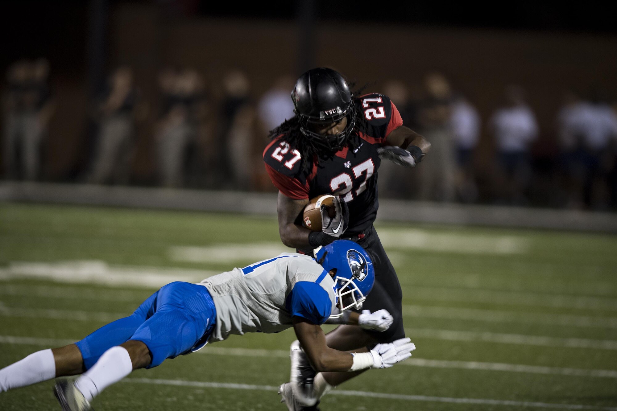 Cedric Hollingshed, Valdosta State University running back, powers through a hit from Tristin Bridges, Shorter University defensive back, during a military appreciation game, Nov. 12, in Valdosta, Ga. Hollingshed finished the game with 84 rushing yards and 28 receiving. (U.S. Air Force photo by Airman 1st Class Daniel Snider)