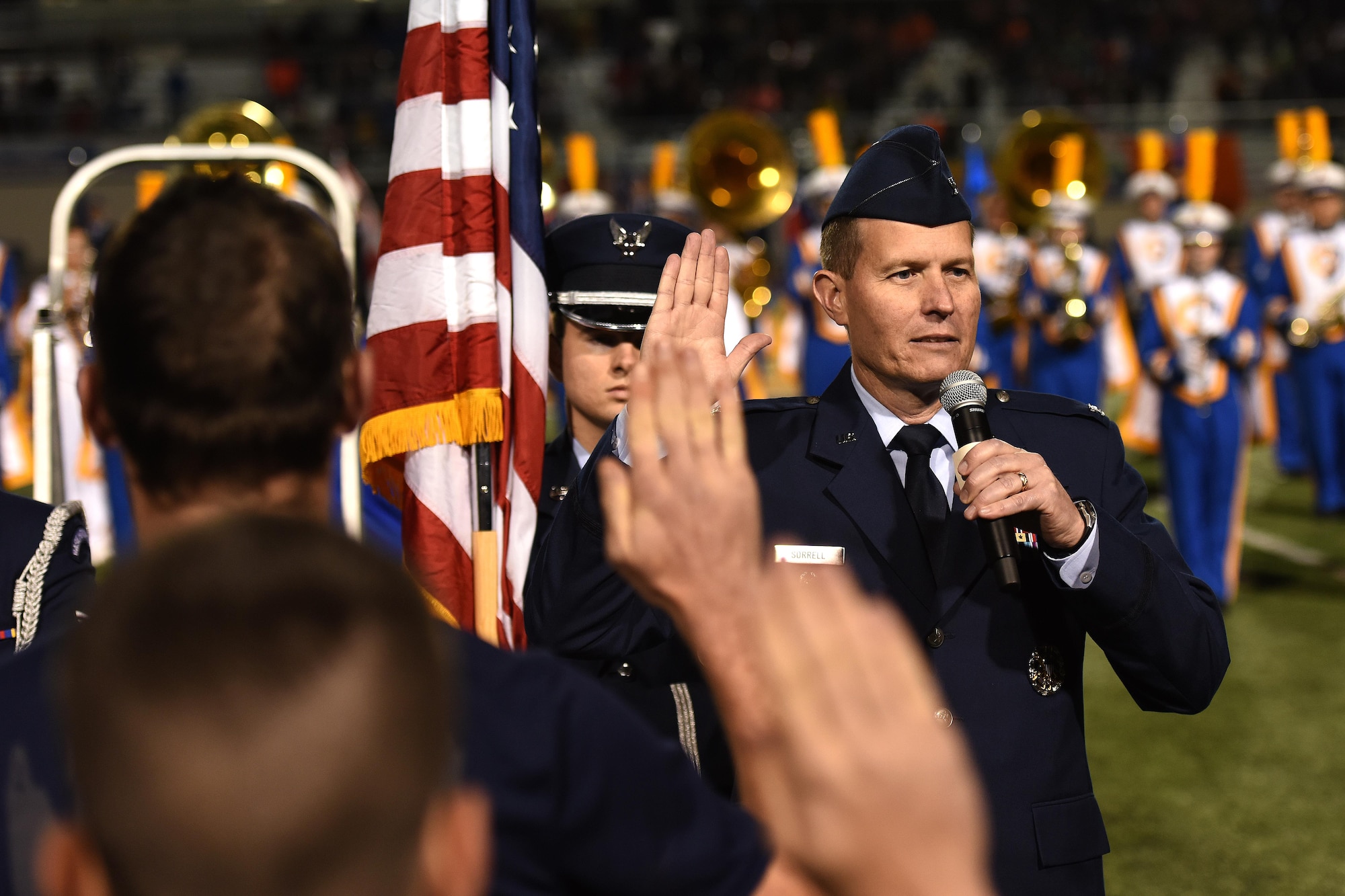 U.S. Air Force Col. Jeffrey Sorrell, 17th Training Wing Vice Commander, swears-in delayed enlistment program members during the Angelo State University Military Appreciation football game at the San Angelo Stadium, Texas, Nov. 12, 2016. The members included enlistees to the U.S. Air Force and the U.S. Navy. (U.S. Air Force photo by Airman 1st Class Caelynn Ferguson/Released)