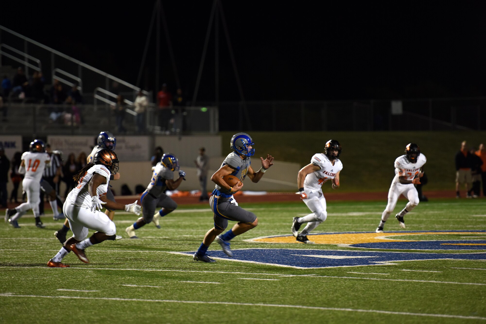 An Angelo State University football player sprints with the ball during the ASU Military Appreciation football game at the San Angelo Stadium, Texas, Nov. 12, 2016. ASU hosted the football game in appreciation of past and present veterans. (U.S. Air Force photo by Airman 1st Class Caelynn Ferguson/Released)