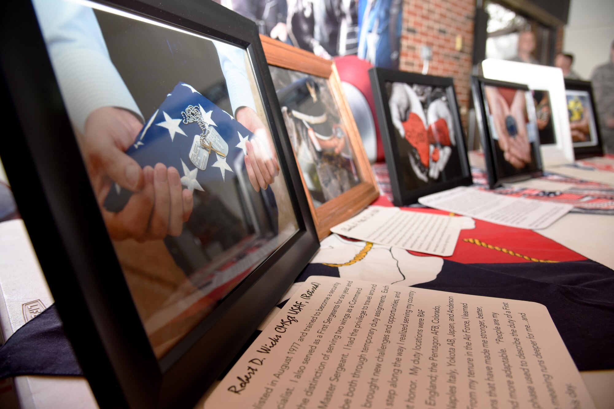 Images from the Hands Display sit on a table at the base theater, on Goodfellow Air Force Base, Texas, Nov. 10, 2016. The images represent both active duty and retired military members’ stories. The Hands Display is an on-going project at Goodfellow to increase awareness of service members’ stories. (U.S. Air Force photo by Senior Airman Joshua Edwards/Released)