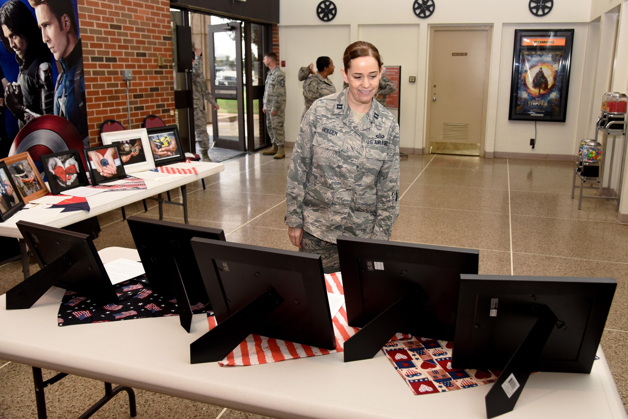 U.S. Air Force Capt. Tanda Holden, 17th Training Wing executive officer, observes the Hands Display at the base theater on Goodfellow Air Force Base, Texas, Nov. 10, 2016. The family advocacy office displayed the hands before a commander’s call to maximize awareness for local veterans. (U.S. Air Force photo by Senior Airman Joshua Edwards/Released)
