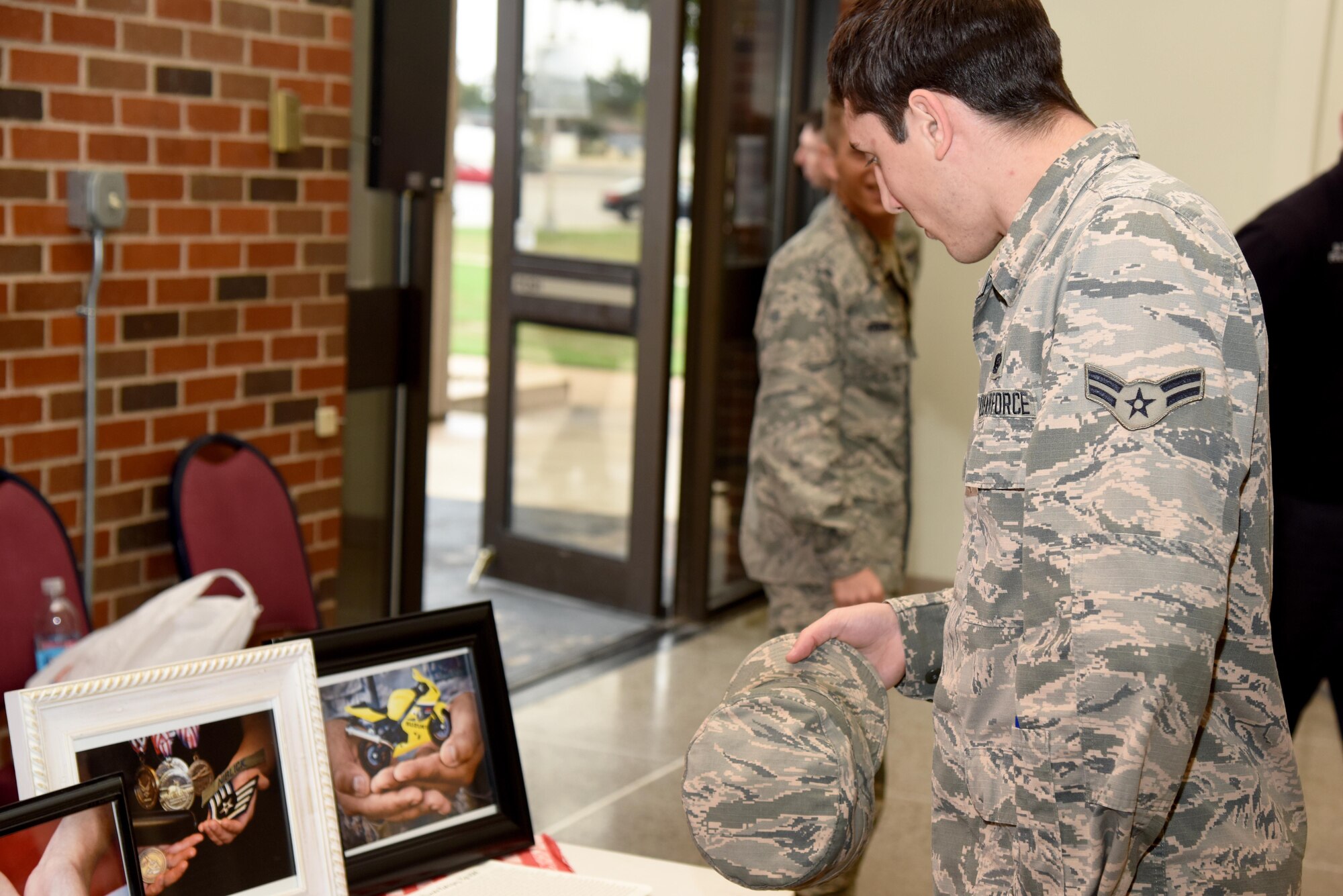 U.S. Air Force Airman 1st Class Troy Maheux, 17th Communications Squadron cybersystem operations apprentice, views the Hands Display at the base theater on Goodfellow Air Force Base, Texas, Nov. 10, 2016. Maheux and other service members had a chance to view the display before the commander’s call. The Hands Display is an on-going project used to show and tell service members’ stories. (U.S. Air Force photo by Senior Airman Joshua Edwards/Released)