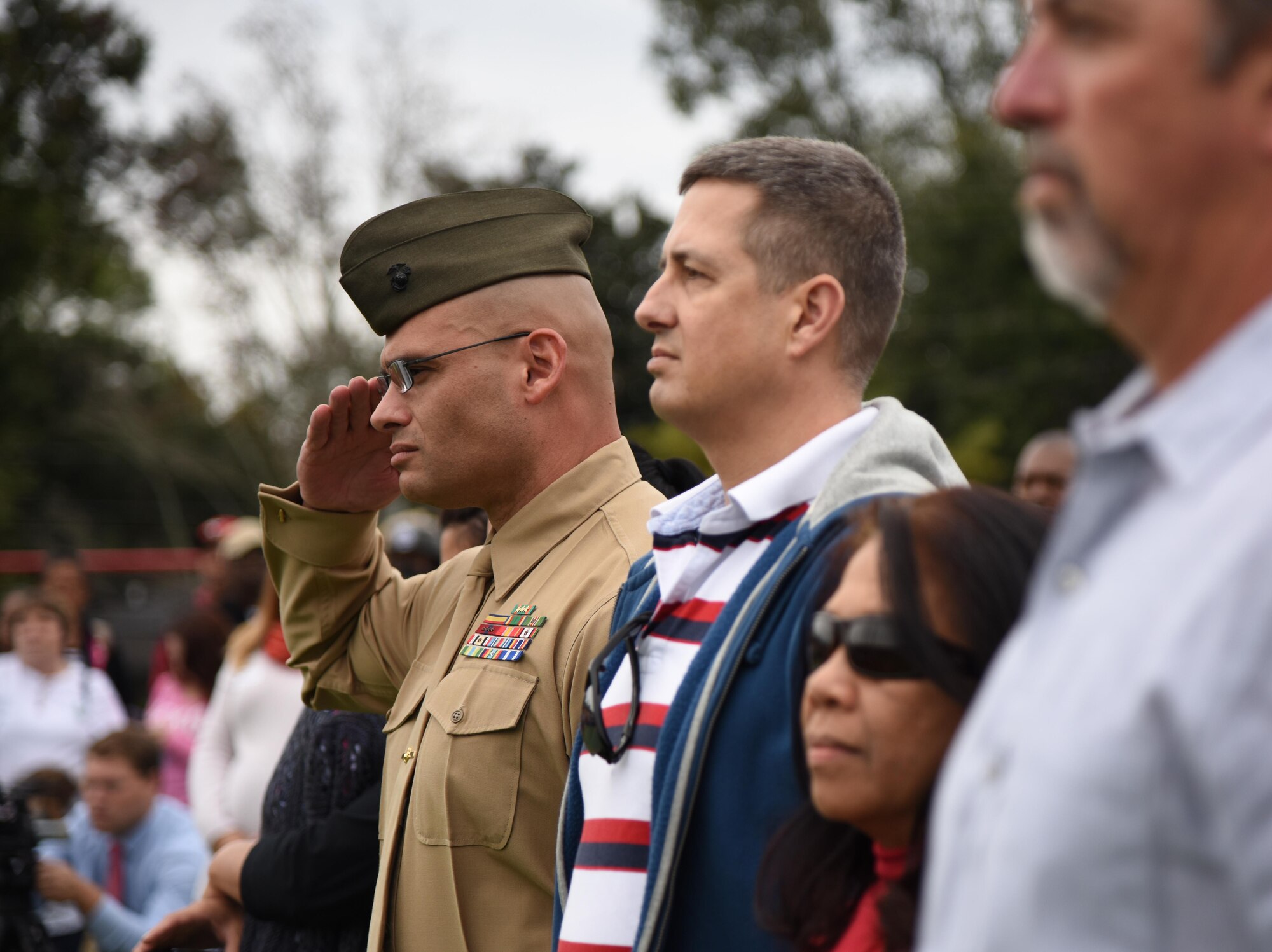 U.S. Marine Gunnery Sgt. Robert Abbott III, Keesler Marine Detachment general calibration aviation mechanic school senior NCO in charge, renders a salute as the U.S. flag is posted during a Jeff Davis Elementary School Veterans Day Celebration Nov. 11, 2016, in Biloxi, Miss. During the event, students delivered the Pledge of Allegiance and sang several patriotic songs. Keesler Air Force Base leadership, Honor Guard Airmen and personnel attended the event. (U.S. Air Force photo by Kemberly Groue/Released)