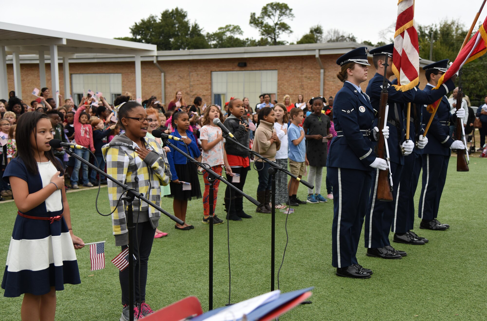 Students at Jeff Davis Elementary School recite the Pledge of Allegiance during a Veterans Day Celebration as the Keesler Honor Guard post the colors Nov. 11, 2016, in Biloxi, Miss. During the event, students delivered the Pledge of Allegiance and sang several patriotic songs. Keesler Air Force Base leadership and personnel attended the event. (U.S. Air Force photo by Kemberly Groue/Released)