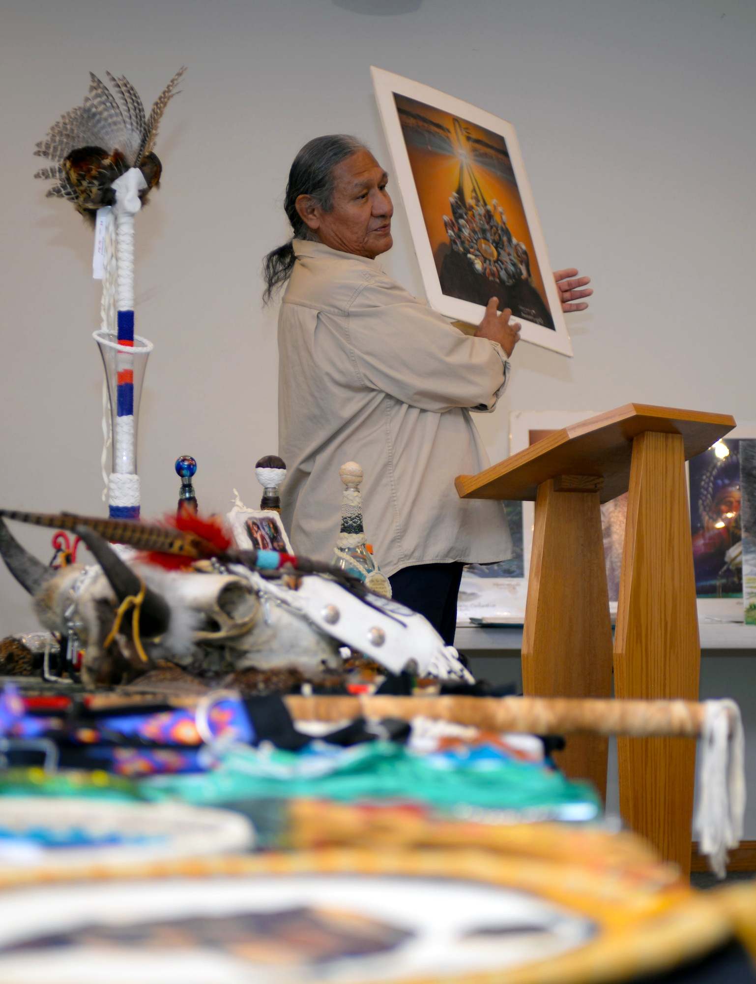 Daryl No Heart, a Lakota native storyteller, holds up a painting of a native prayer circle during a food tasting and storytelling event celebrating National Native American Heritage Month at Ellsworth Air Force Base, S.D., Nov. 10, 2016. No Heart spoke on his life experiences growing up and the importance of keeping Native American spirit and culture alive. (U.S. Air Force photo by Airman 1st Class Denise M. Jenson)