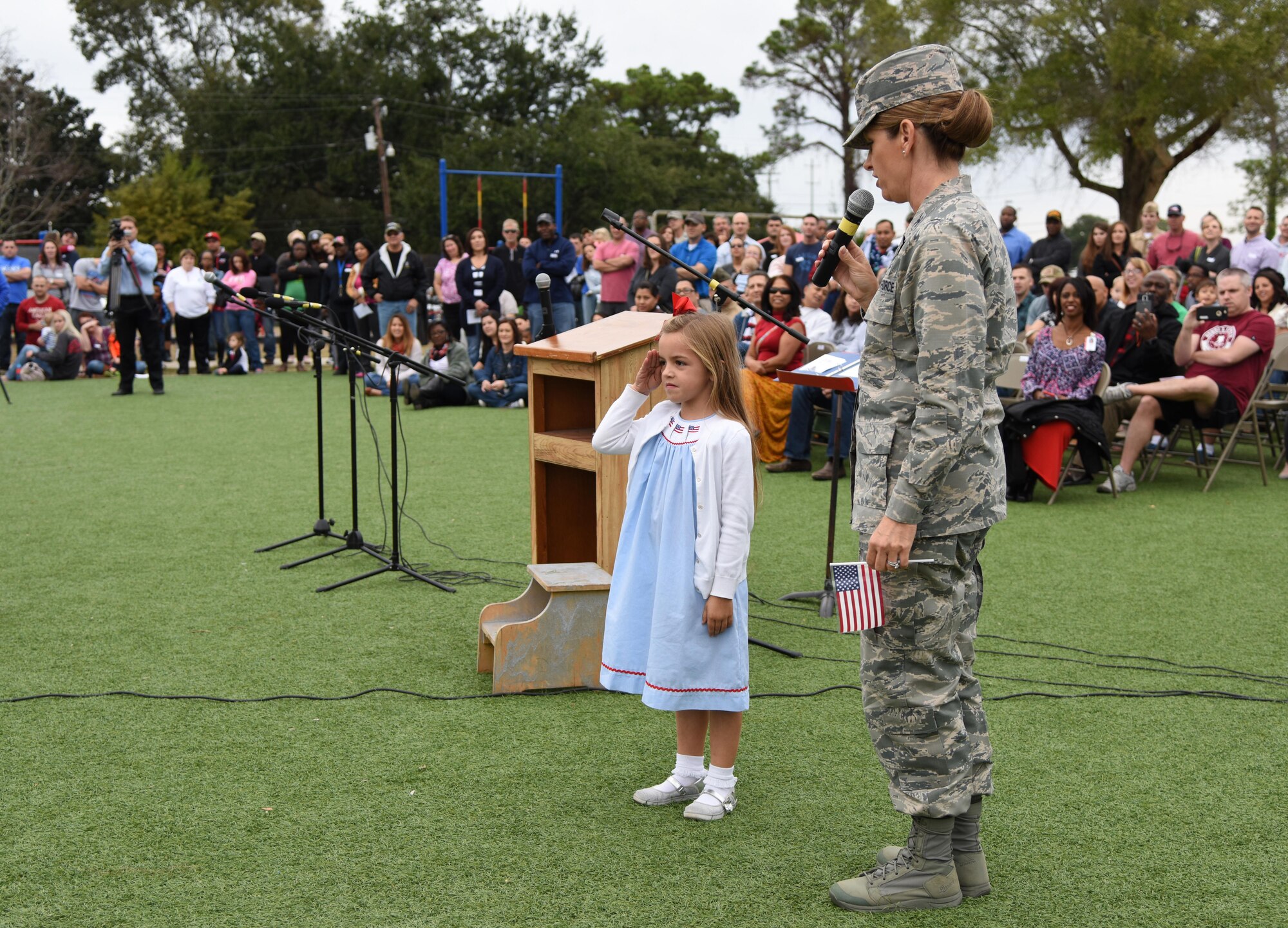 Col. Michele Edmondson, 81st Training Wing commander, introduces her daughter, Jacqueline McGowan, as she demonstrates how to render a salute during a Jeff Davis Elementary School Veterans Day Celebration Nov. 11, 2016, in Biloxi, Miss. During the event, students delivered the Pledge of Allegiance and sang several patriotic songs. The Keesler Honor Guard and other service members also participated in the event. (U.S. Air Force photo by Kemberly Groue/Released)