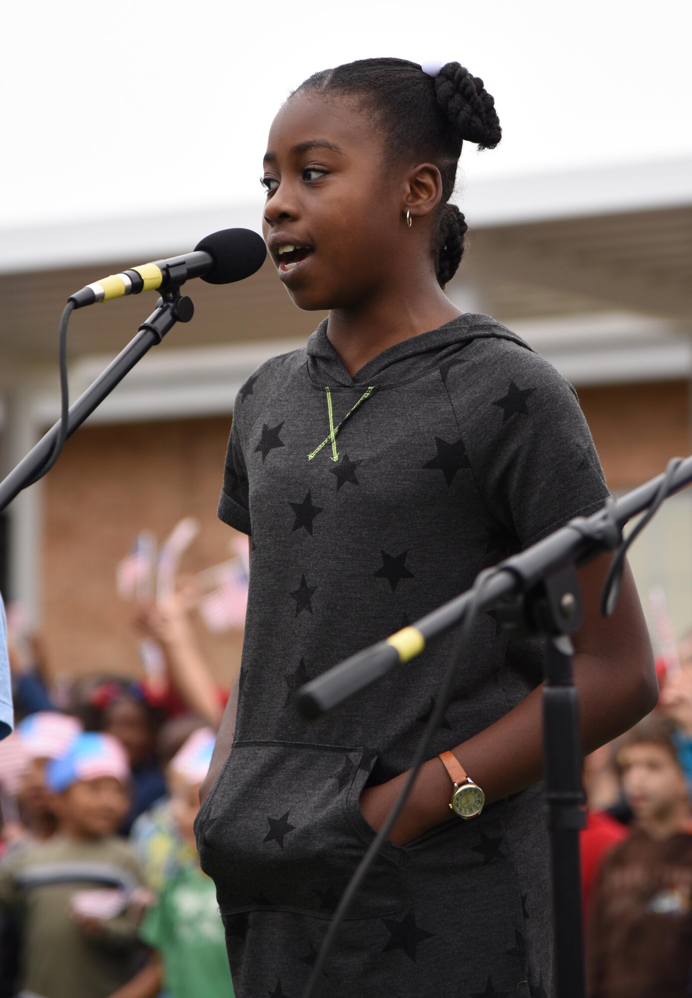Aysiah Sims, daughter of Maj. Jahayra Lowe, 81st Comptroller Squadron commander, sings the “Allegiance Rap” song during a Jeff Davis Elementary School Veterans Day Celebration Nov. 11, 2016, in Biloxi, Miss. During the event, students delivered the Pledge of Allegiance and sang several patriotic songs. The Keesler Honor Guard and other service members also participated in the event. (U.S. Air Force photo by Kemberly Groue/Released)