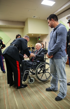 Brigadier General William M. Jurney, commanding general, Marine Corps Recruit Depot San Diego/Western Recruiting Region, hands cake to the oldest and youngest Marine veterans at the Veterans Affairs San Diego Healthcare System, Nov. 7. Jurney took part in a cake cutting ceremony in celebration of the Marine Corps’ 241st birthday, which is Nov. 10, 1775. Traditionally, the first two pieces of cake are presented to the oldest and youngest Marines present, which symbolizes the passing of Marine Corps traditions.