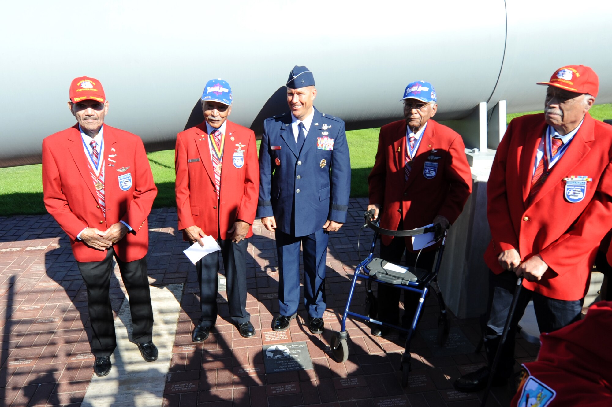 Brig. Gen. Brook Leonard, 56th Fighter Wing commander, stands with members of the Archer-Ragsdale Arizona Chapter Tuskegee Airmen Incorporated, beside the Tuskegee Redtail granite paver Nov. 11, 2016 at the Wesley Bolin Memorial Plaza, Phoenix, Ariz. The granite paver was placed between the gun barrel monuments for the U.S.S Arizona and the U.S.S Missouri gun in memory of the Tuskegee Airmen who served in World War II. (U.S. Air Force photo by Airman 1st Class Pedro Mota)