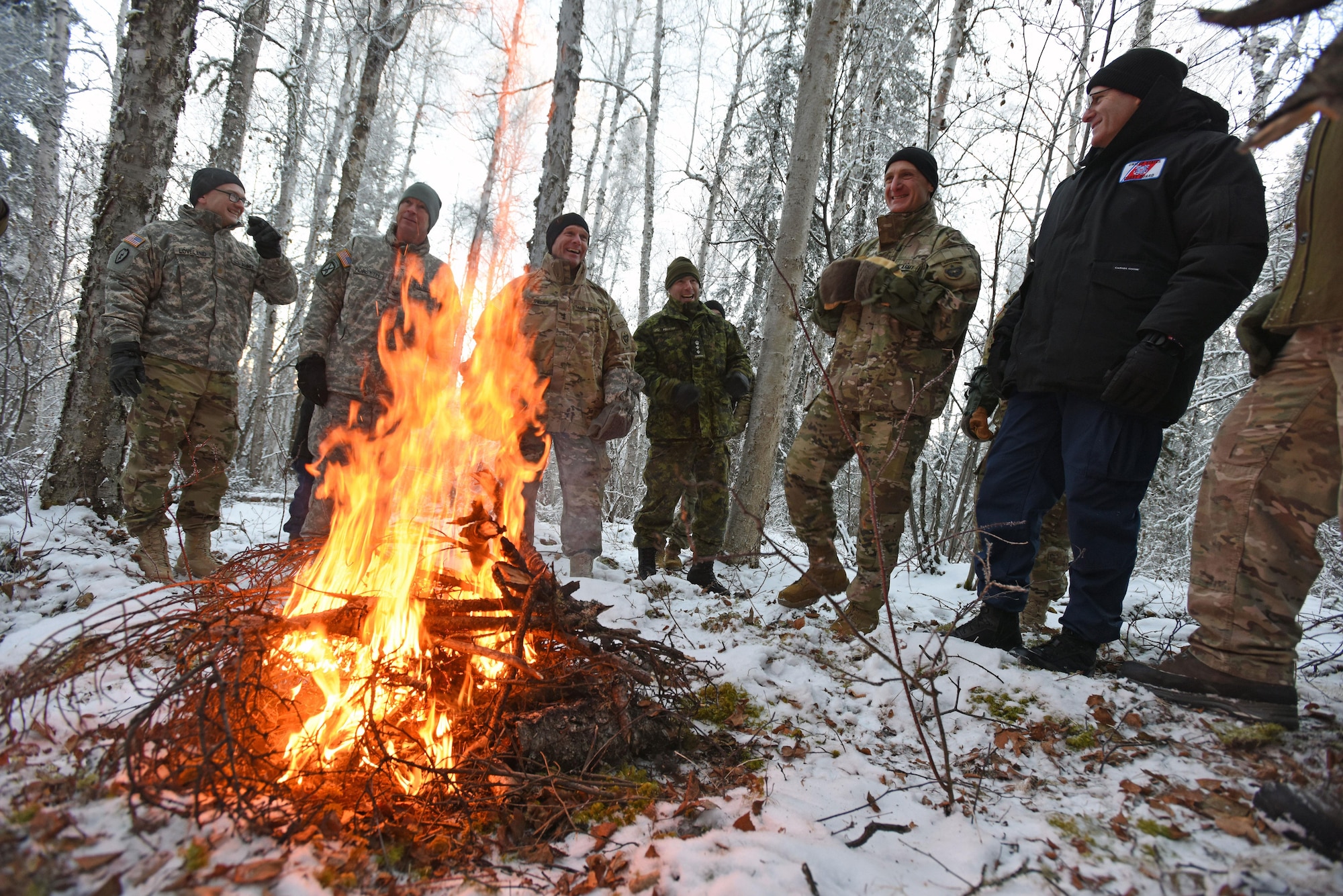 Participants of the Arctic General Officer/Flag Officer Summit discuss Arctic resources and challenges around a warm campfire while touring Arctic Cool School assets and resources Nov. 9. U.S. U.S. Air Force Lt. Gen. Ken Wilsbach, Alaskan NORAD Region, Alaskan Command and 11th Air Force commander and U.S. Army Maj. Gen. Bryan Owens, U.S. Army Alaska commander hosted the conference, which included flag officers from the U.S. Air Force, U.S. Army, U.S. Coast Guard, Alaska National Guard and Canadian Forces, to strengthen partnerships, discuss future Arctic and Alaskan challenges and joint capabilities.