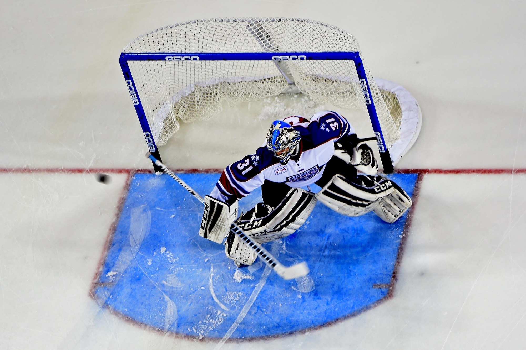 Alaska Aces goalie Kevin Carr blocks a puck during a pre-game warmup at Sullivan Arena in Anchorage, Alaska, Nov. 11, 2016. The Alaska Aces honored veterans for their service with a military appreciation weekend Nov. 11 and 12. 