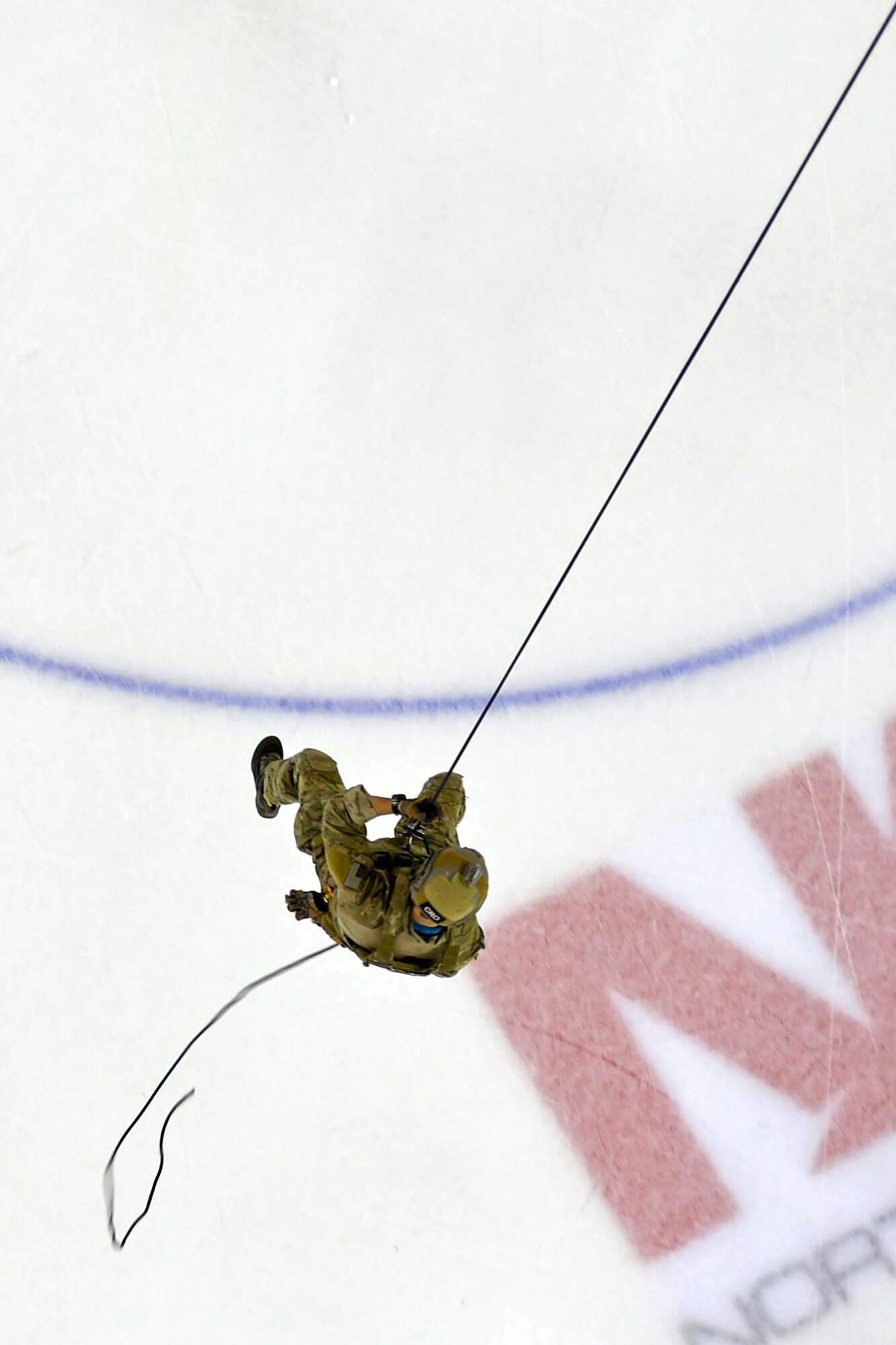A pararescue Airman rappels from the rafters to deliver the puck before an Alaska Aces military appreciation game against the Indianapolis Fuel at Sullivan Arena at Anchorage Alaska, Nov. 11, 2016. 