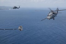 An MC-130H Combat Talon II from the 1st Special Operations Squadron refuels an HH-60 Pave Hawk from the 943rd Rescue Group during Exercise Keen Sword 17 Nov. 7, 2016, near Okinawa, Japan. Keen Sword is the latest in a series of joint/bilateral field training exercises since 1986 involving U.S. military and Japan Self-Defense Force designed to increase combat readiness and interoperability of U.S. forces and the JSDF. (U.S. Air Force photo by Airman 1st Class Corey M. Pettis)