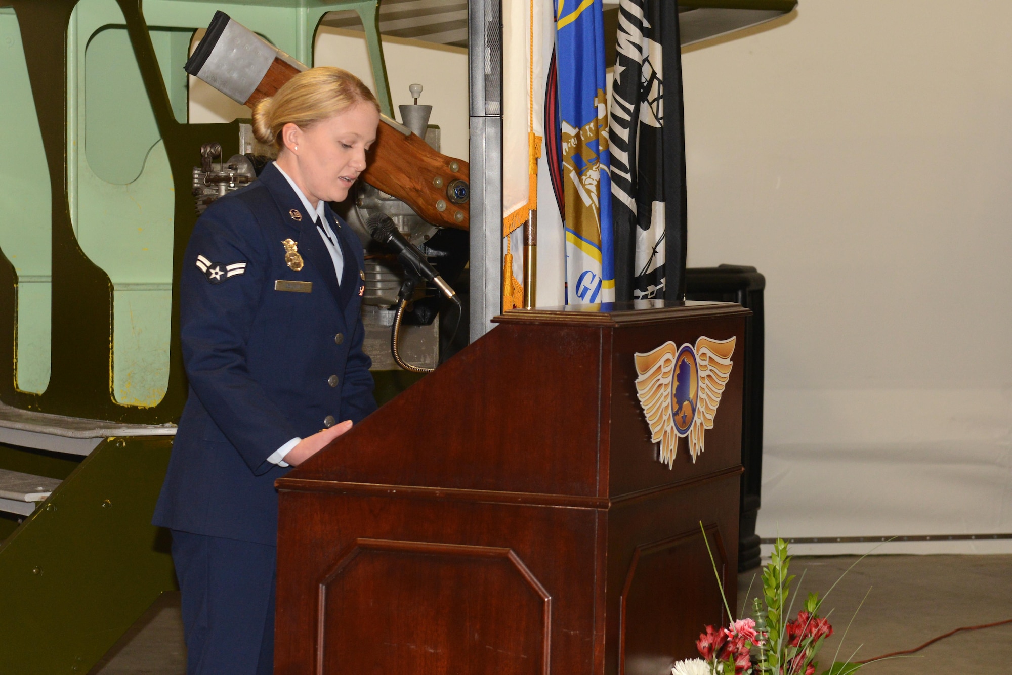 Airman 1st Class Hailee Euland, 673d Security Forces Squadron installation entry controller, reads an excerpt from the Alaska governor’s proclamation as part of the Women Veterans Recognition ceremony hosted by the Women Veterans Program at the Alaska Aviation Museum, Anchorage, Nov. 9, 2016. The event recognized and highlighted the contributions female veterans have made and continue to make in the military.