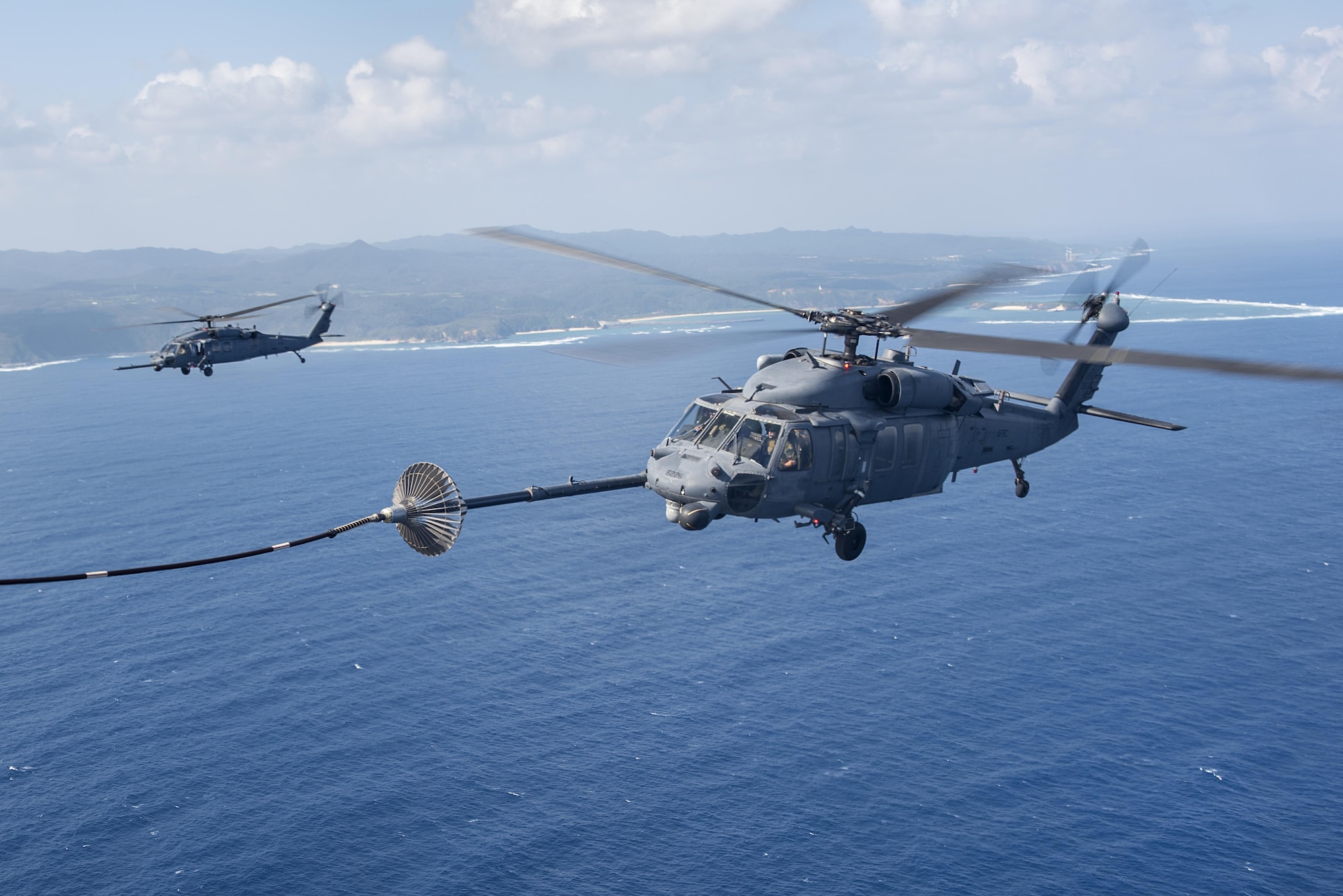 An MC-130H Combat Talon II from the 1st Special Operations Squadron refuels an HH-60 Pave Hawk from the 943rd Rescue Group during Exercise Keen Sword 17 Nov. 7, 2016, near Okinawa, Japan. U.S. forces will conduct training with their Japan Self-Defense Force counterparts at military installations throughout mainland Japan, Okinawa and in the waters surrounding Japan. (U.S. Air Force photo by Airman 1st Class Corey M. Pettis)