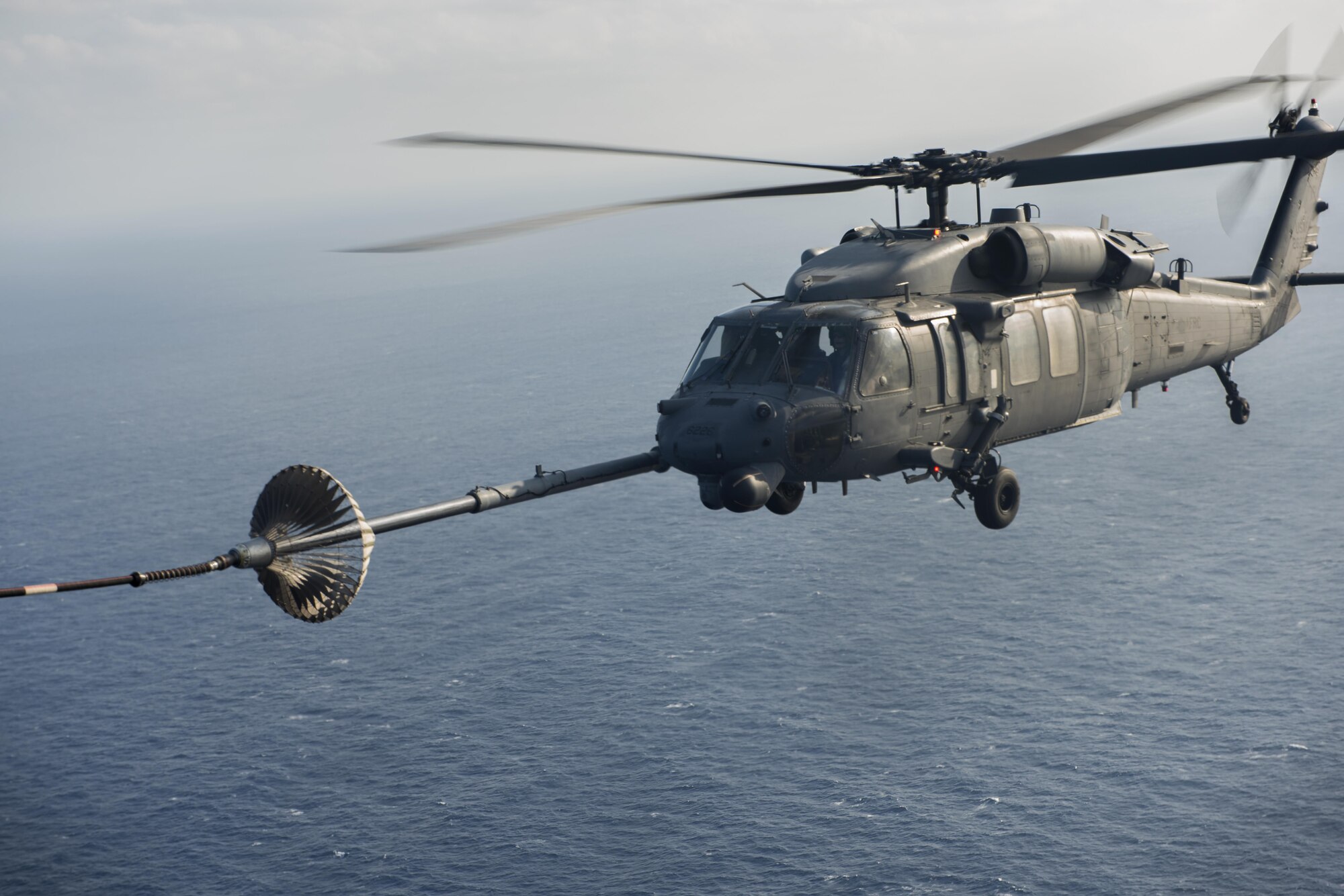An MC-130H Combat Talon II from the 1st Special Operations Squadron refuels an HH-60 Pave Hawk from the 943rd Rescue Group during Exercise Keen Sword 17 Nov. 7, 2016, near Okinawa, Japan. The 353rd Special Operations Group supported Keen Sword 17 by providing a refueling point for U.S. and Japan Air Self-Defense Force HH-60 Pave Hawks. (U.S. Air Force photo by Airman 1st Class Corey M. Pettis)