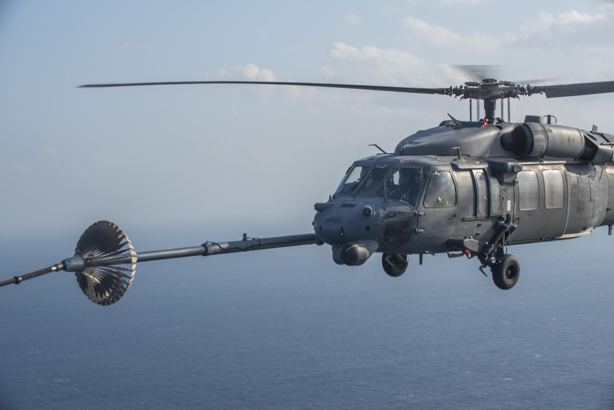 An MC-130H Combat Talon II from the 1st Special Operations Squadron refuels an HH-60 Pave Hawk from the 943rd Rescue Group during Exercise Keen Sword 17 Nov. 7, 2016, near Okinawa, Japan. Keen Sword is a joint and bilateral defense exercise designed to practice defending Japan against foreign aggression. (U.S. Air Force photo by Airman 1st Class Corey M. Pettis)