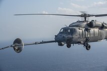 An MC-130H Combat Talon II from the 1st Special Operations Squadron refuels an HH-60 Pave Hawk from the 943rd Rescue Group during Exercise Keen Sword 17 Nov. 7, 2016, near Okinawa, Japan. Keen Sword is a joint and bilateral defense exercise designed to practice defending Japan against foreign aggression. (U.S. Air Force photo by Airman 1st Class Corey M. Pettis)