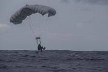 A Japan Air Self-Defense Force pararescueman parachutes into the ocean during Exercise Keen Sword 17 Nov. 10, 2016, at Kadena Air Base, Japan. The pararescuemen practiced jumping into the ocean to save survivors from a simulated aircraft crash. (U.S. Air Force photo by Airman 1st Class Corey M. Pettis)