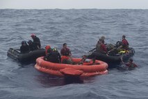 Japan Air Self-Defense Force and 31st Rescue Squadron pararescuemen rescue survivors of a simulated aircraft crash during Exercise Keen Sword 17 Nov. 10, 2016, near Okinawa, Japan. The survivors were pulled off the raft and later hoisted up into rescue helicopters. (U.S. Air Force photo by Airman 1st Class Corey M. Pettis)