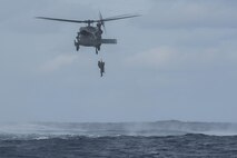 An HH-60 Pave Hawk from the 33rd Rescue Squadron hoists up a pararescueman from the 31st RS and simulated survivors during Exercise Keen Sword 17 Nov. 10, 2016, near Okinawa, Japan. Japan Air Self-Defense Force and 31st RS pararescuemen parachuted into the ocean to rescue simulated survivors on a life raft. (U.S. Air Force photo by Airman 1st Class Corey M. Pettis)