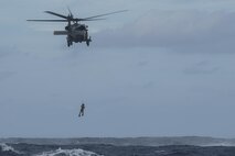 An HH-60 Pave Hawk from the 33rd Rescue Squadron hoists up a pararescueman from the 31st RS and simulated survivors during Exercise Keen Sword 17 Nov. 10, 2016, near Okinawa, Japan. KS17 involves U.S. forces and the JASDF from all components of both militaries, training to conduct bilateral operations in support of the defense of Japan. (U.S. Air Force photo by Airman 1st Class Corey M. Pettis)