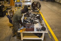 Cpl. Marcus Hardimon cleans a gasket on a valve cover, Nov. 8, 2016, at Camp Kinser, Okinawa, Japan. Marines took apart, cleaned, and assembled an engine of a High Mobility Multipurpose Wheeled Vehicle. Hardimon is an automotive maintenance technician with 3rd Marine Logistics Group, III Marine Expeditionary Force. (U.S. Marine Corps photo by Cpl Nathaniel Cray / Released)