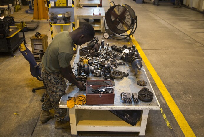 Cpl. Marcus Hardimon cleans a gasket on a valve cover, Nov. 8, 2016, at Camp Kinser, Okinawa, Japan. Marines took apart, cleaned, and assembled an engine of a High Mobility Multipurpose Wheeled Vehicle. Hardimon is an automotive maintenance technician with 3rd Marine Logistics Group, III Marine Expeditionary Force. (U.S. Marine Corps photo by Cpl Nathaniel Cray / Released)