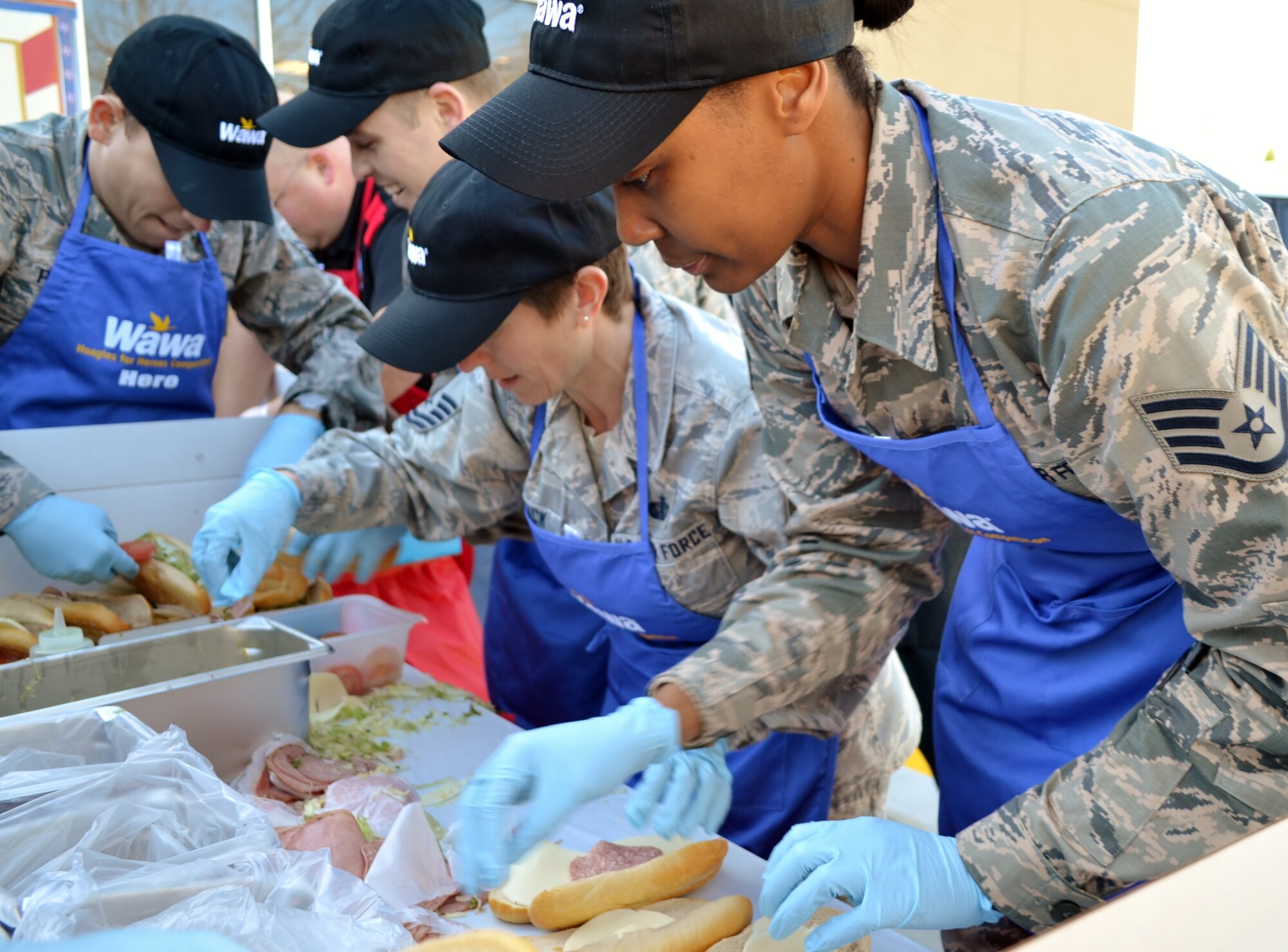 From right to left, Staff Sgt. Charlissa Adams, Master Sgt. Danielle Heidrick, Senior Airman Igor Karlov and Staff Sgt. Heikell Perez, all from the 111th Attack Wing at Horsham Air Guard Station, Pa., furiously assemble hoagies for the Liberty USO in an event hosted by Wawa Inc., in Cheltenham, Pa., Nov. 10, 2016. The Air Guard team raised $1,500 for the USO chapter that supports Pennsylvania and southern New Jersey. (U.S. Air National Guard photo by Tech. Sgt. Andria Allmond)
