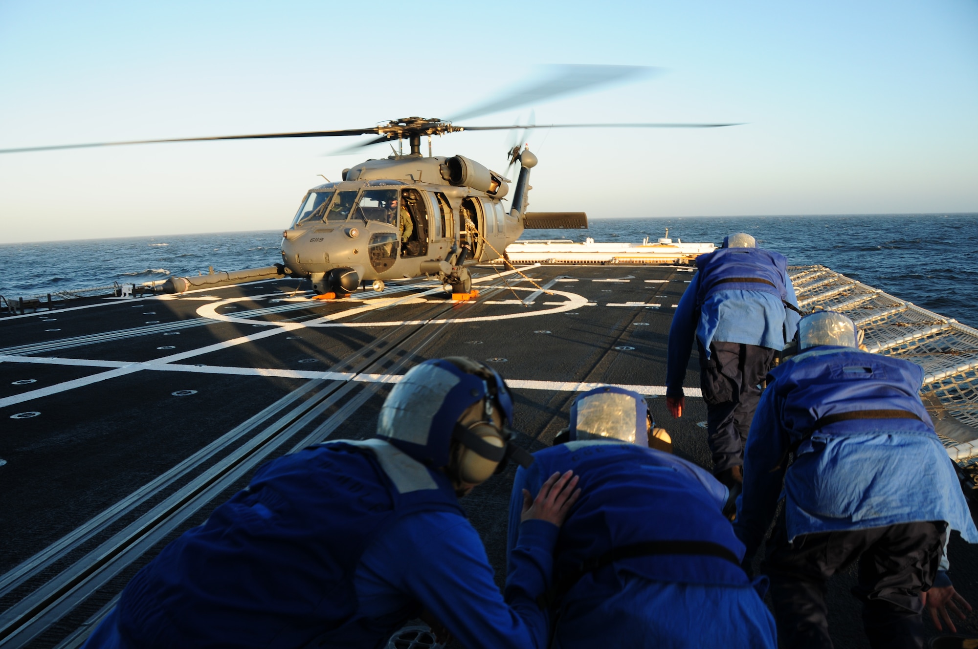 California Air National Guard members assigned to the 129th Rescue Squadron conduct aircraft deck landing qualifications with the United States Coast Guard, approximately 25 nautical miles off the coast of Northern California, June 20, 2012. This is the first landing of an Air Force HH-60G Pave Hawk on the National Security Coast Guard Cutter, USCG Bertholf. (Air National Guard photo by Staff Sgt. Kim E. Ramirez/released)