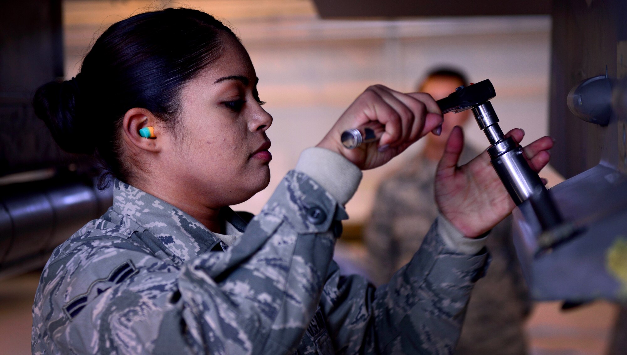 Airman 1st Class Arlene Castro-Lopez, 31st Aircraft Maintenance Squadron weapons load crew member, loosens bolts during a weapons loading demonstration at Aviano Air Base, Italy on Nov. 11, 2016. Weapons load crew members are responsible for loading and unloading munitions on Team Aviano’s F-16 Fighting Falcons.  (U.S. Air Force photo by Senior Airman Areca T. Bell)