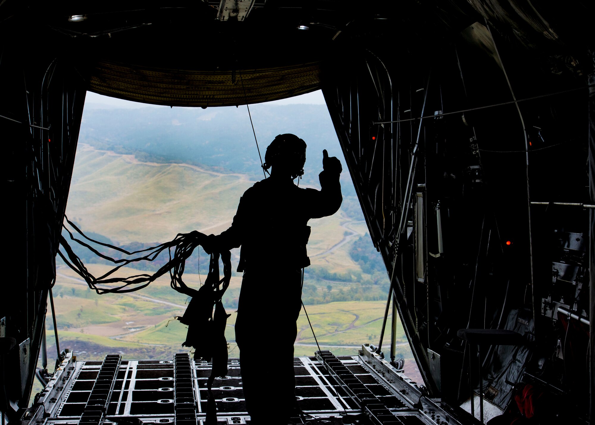 Senior Airman Anthony Schoof, 36th Airlift Squadron C-130 Hercules loadmaster, observes Japan Ground Self-Defense Force container delivery system bundles parachute to a drop zone during Keen Sword 2017, Nov. 10, 2016, over the Kyushu prefecture, Japan. Keen Sword is designed to practice the critical capabilities to support the defense of Japan, and to respond to a potential crisis or contingency in the Indo-Asia-Pacific region. (U.S. Air Force photo by Airman 1st Class Donald Hudson/Released)