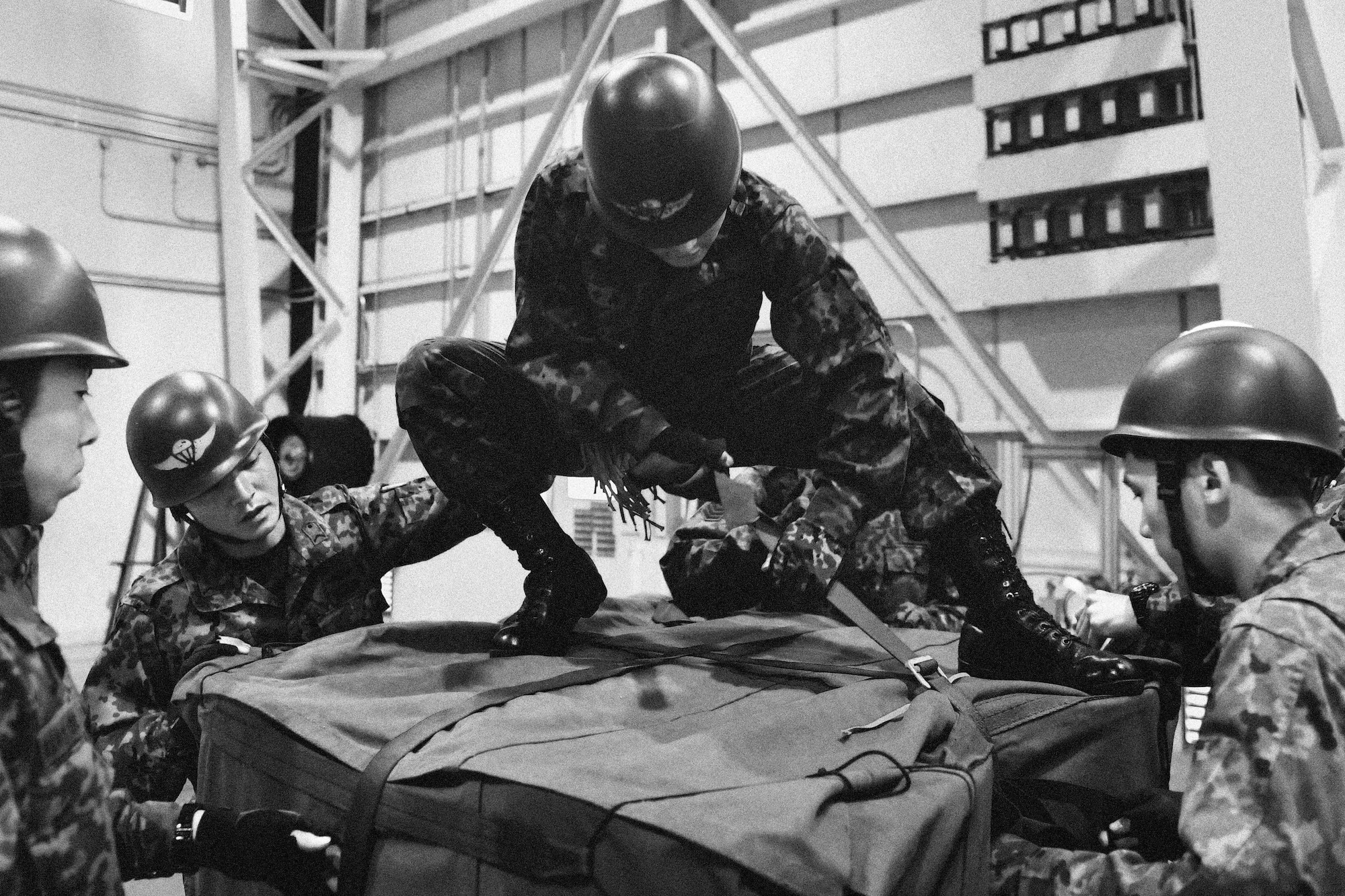 Japan Ground Self-Defense Force members tie down a container delivery system bundle at Yokota Air Base, Japan, Nov. 7, 2016. Exercises such as KS17 provide a real-world training environment for enhancing mutual understanding of each country's tactics, communication protocols, procedures and general interoperability. (U.S. Air Force photo by Senior Airman Delano Scott/Released)