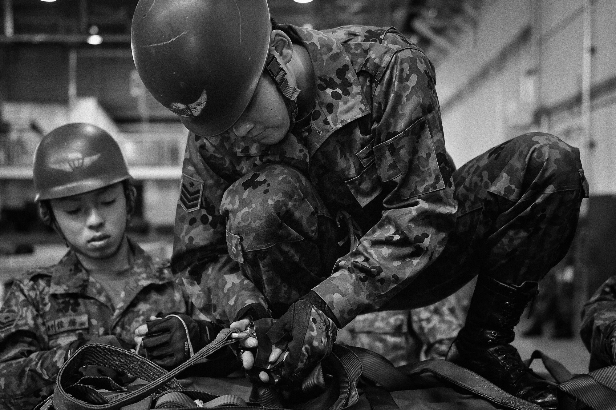 Japan Ground Self-Defense Force members tie down a container delivery system bundle during Keen Sword 2017 at Yokota Air Base, Japan, Nov. 7, 2016. Exercises such as KS17 provide a real-world training environment for enhancing mutual understanding of each country's tactics, communication protocols, procedures and general interoperability. (U.S. Air Force photo by Senior Airman Delano Scott/Released)
