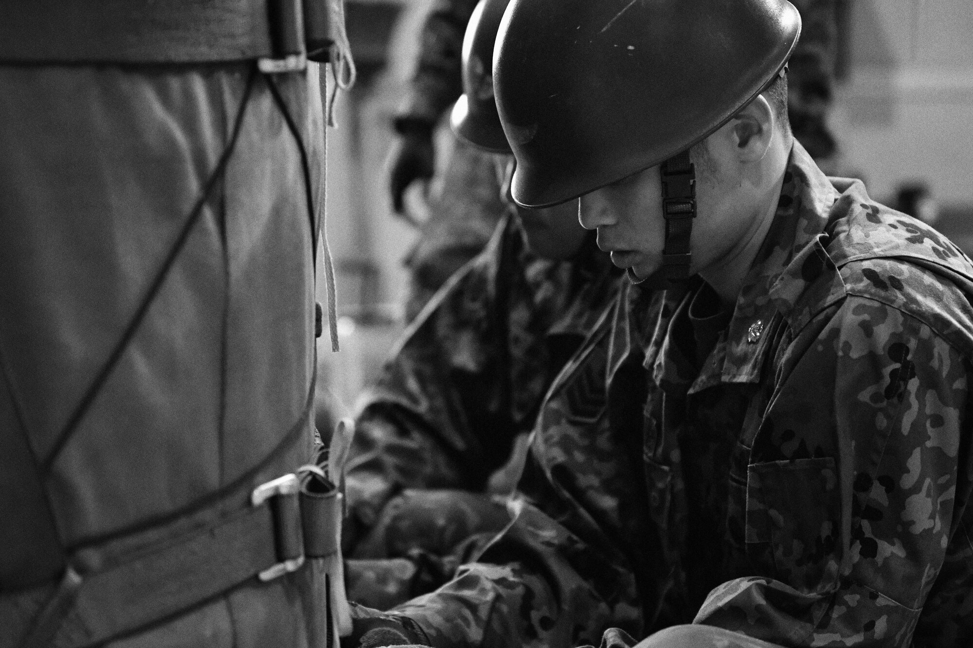 Japan Ground Self-Defense Force members tie down a container delivery system bundle during Keen Sword 2017 at Yokota Air Base, Japan, Nov. 7, 2016. Exercises such as KS17 provide a real-world training environment for enhancing mutual understanding of each country's tactics, communication protocols, procedures and general interoperability. (U.S. Air Force photo by Senior Airman Delano Scott/Released)

