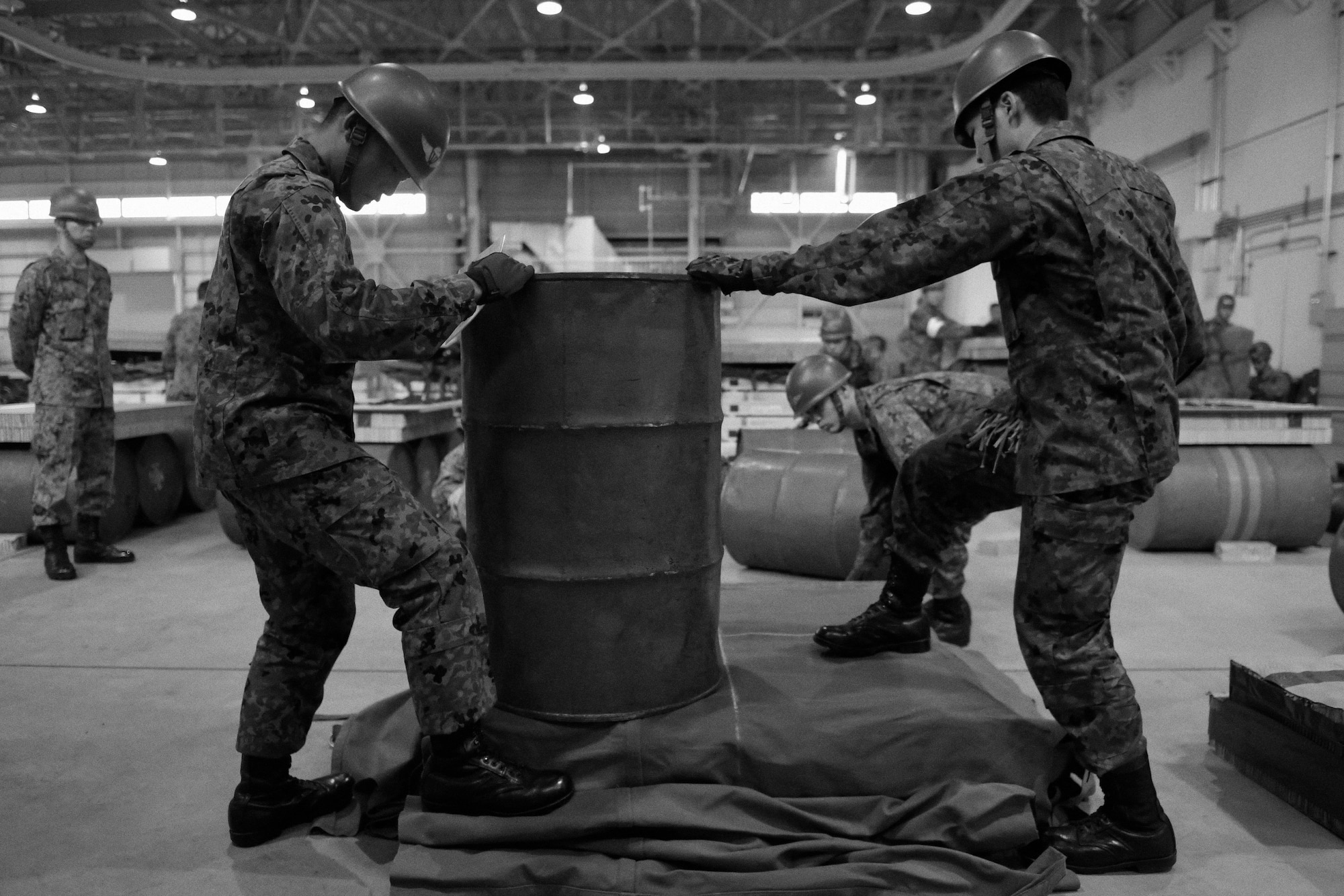 Japan Ground Self-Defense Force members prepare to construct a container delivery system bundle at Yokota Air Base, Japan, Nov. 7, 2016. As part of Keen Sword 17, U.S. and Japan Self-Defense Force members participated in C-17 Globemaster III tie-down training, UH-1N Iroquois night flight familiarization and C-130 Hercules container delivery system bundle drops, each designed to increase combat readiness and interoperability within the framework of the U.S.-Japan alliance. (U.S. Air Force photo by Senior Airman Delano Scott/Released)